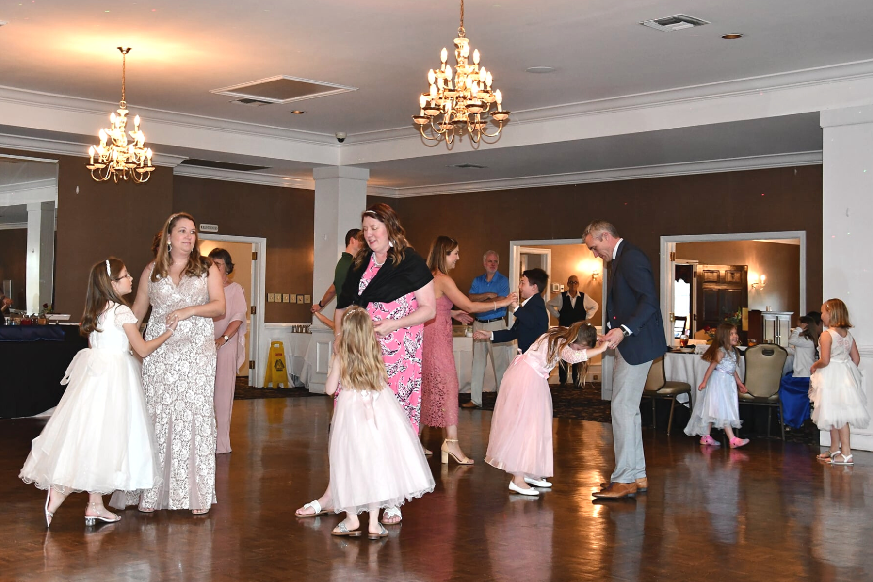 Adults dancing with girls on the ballroom floor at Darlington Country Club