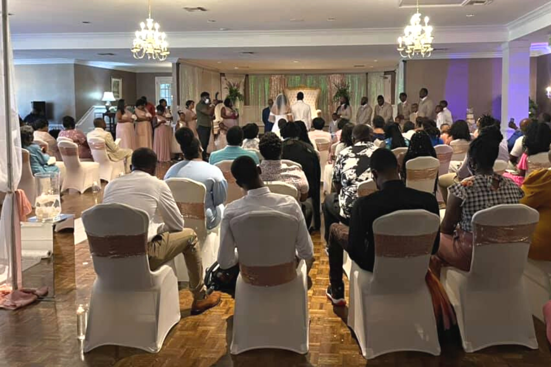 Wedding venue room with a wooden floor and full attendance of the bride and groom's families at Darlington Country Club