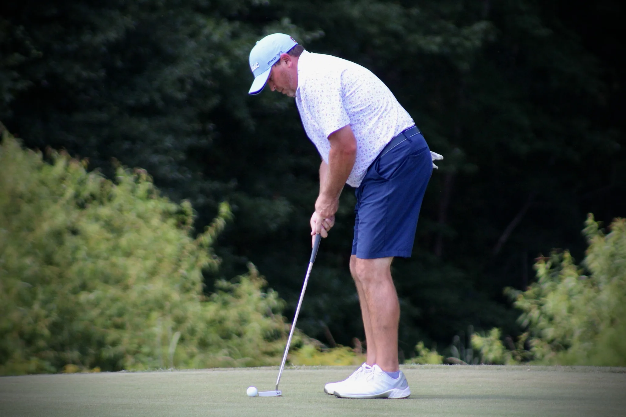 Golfer putting a golf ball on the green at Darlington Country Club.