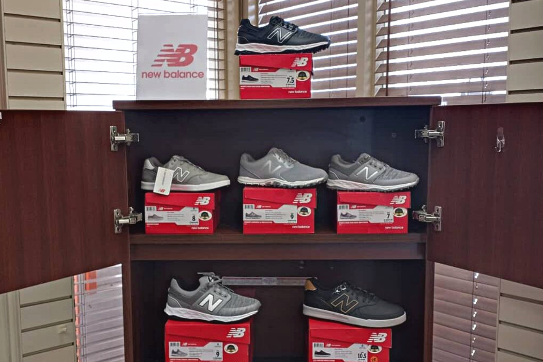 New Balance Sneakers | Pro Shop Footwear A display shelf with various New Balance sneakers.
