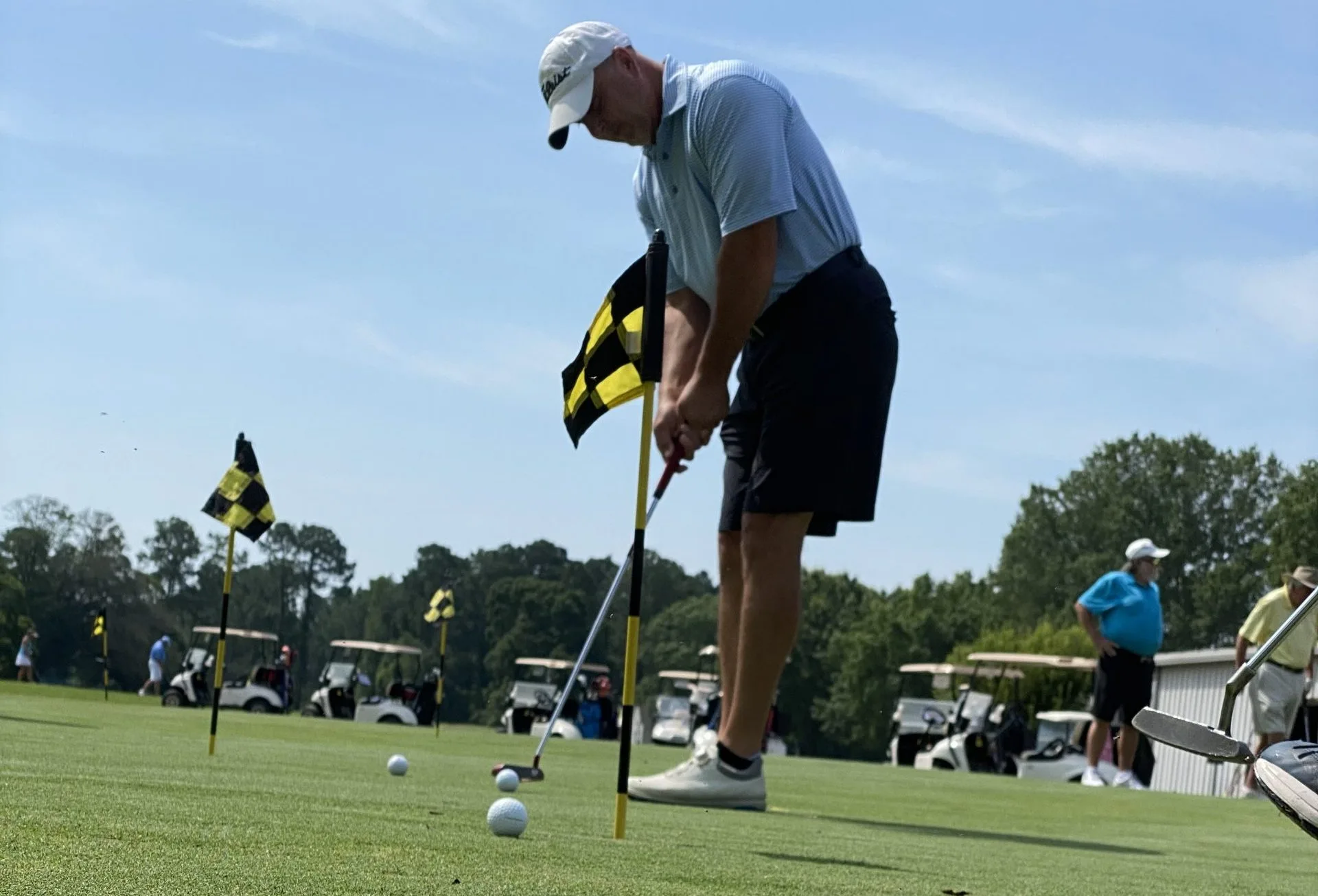 Golfer practicing his putting skills at the Darlington Country Club Practice Facility.